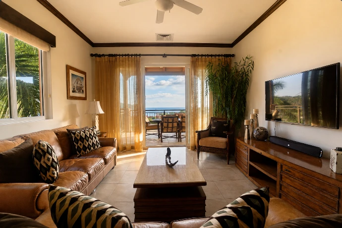 Open-plan living and dining area at Altavista 1A, featuring warm natural light, refined tropical interiors, and Pacific Ocean views at Los Sueños Resort, Costa Rica.