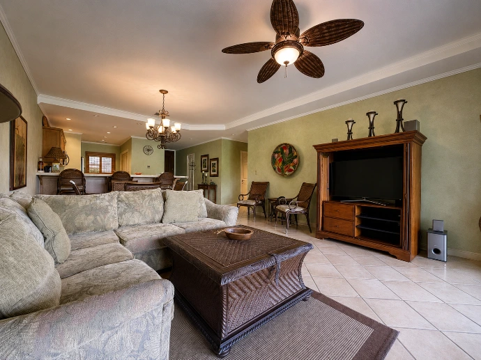 Warm and inviting living room at Del Mar 4P, a garden-level residence surrounded by tropical gardens near La Iguana Golf Course in Los Sueños Resort, Costa Rica.