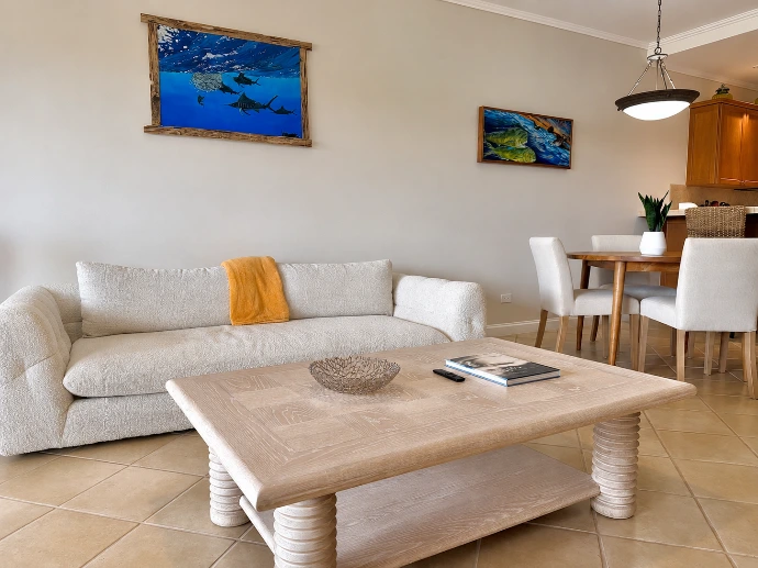 Living room seating area with an adjoining dining space at Del Mar 4D in Los Sueños Resort.