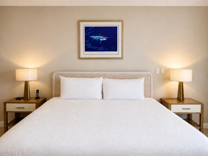 Primary bedroom with white bedding and matching bedside tables at Del Mar 4D in Los Sueños Resort.